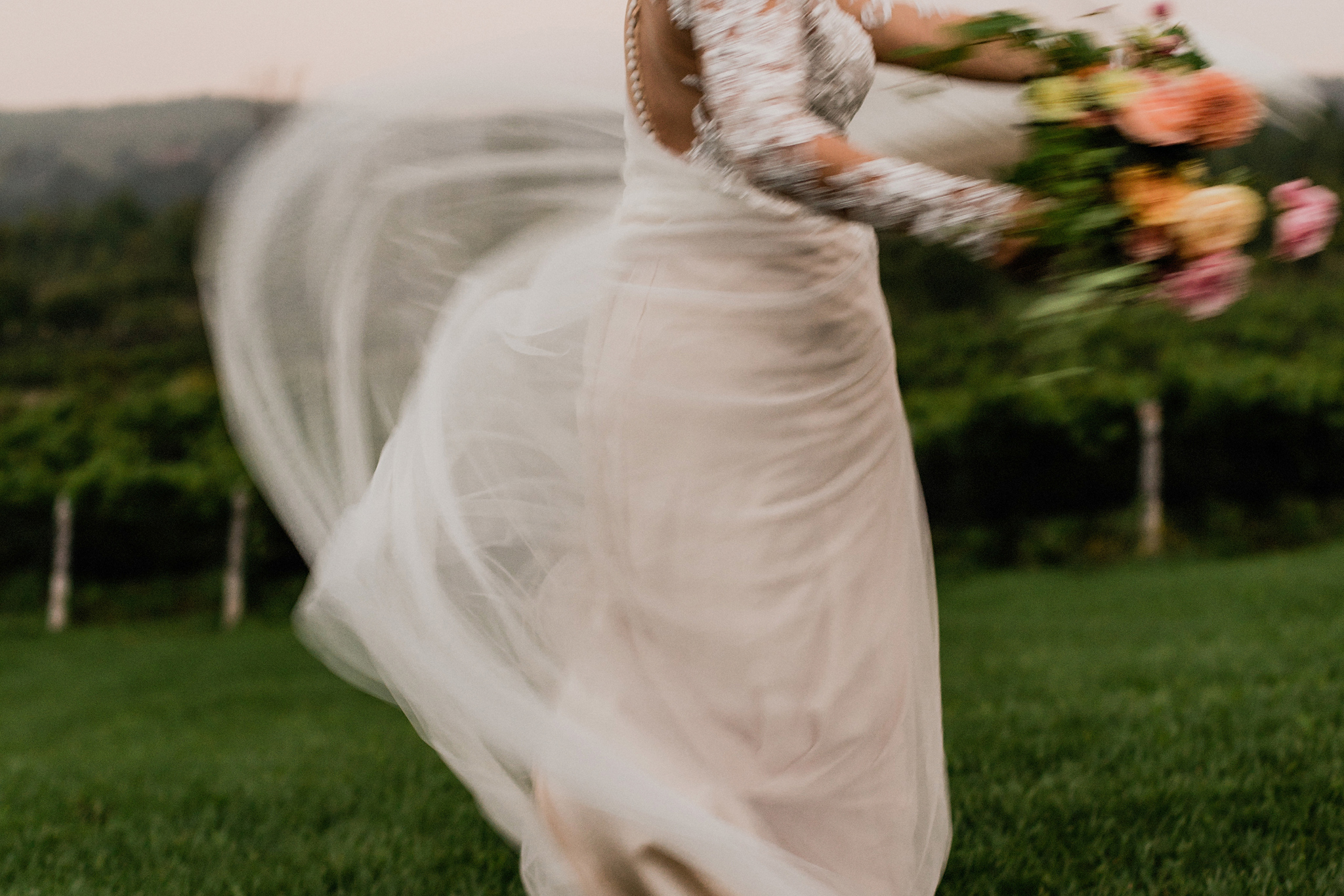 Bride swishes her chiffon and lace gown at Coffin Ridge Boutique