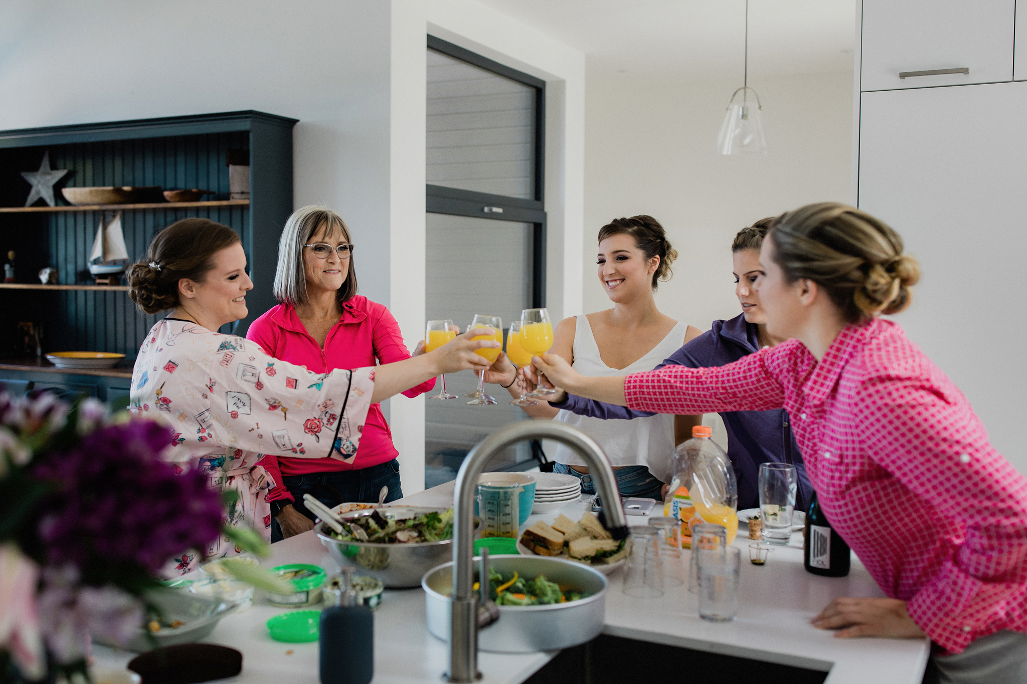 bridal party toast with mimosas
