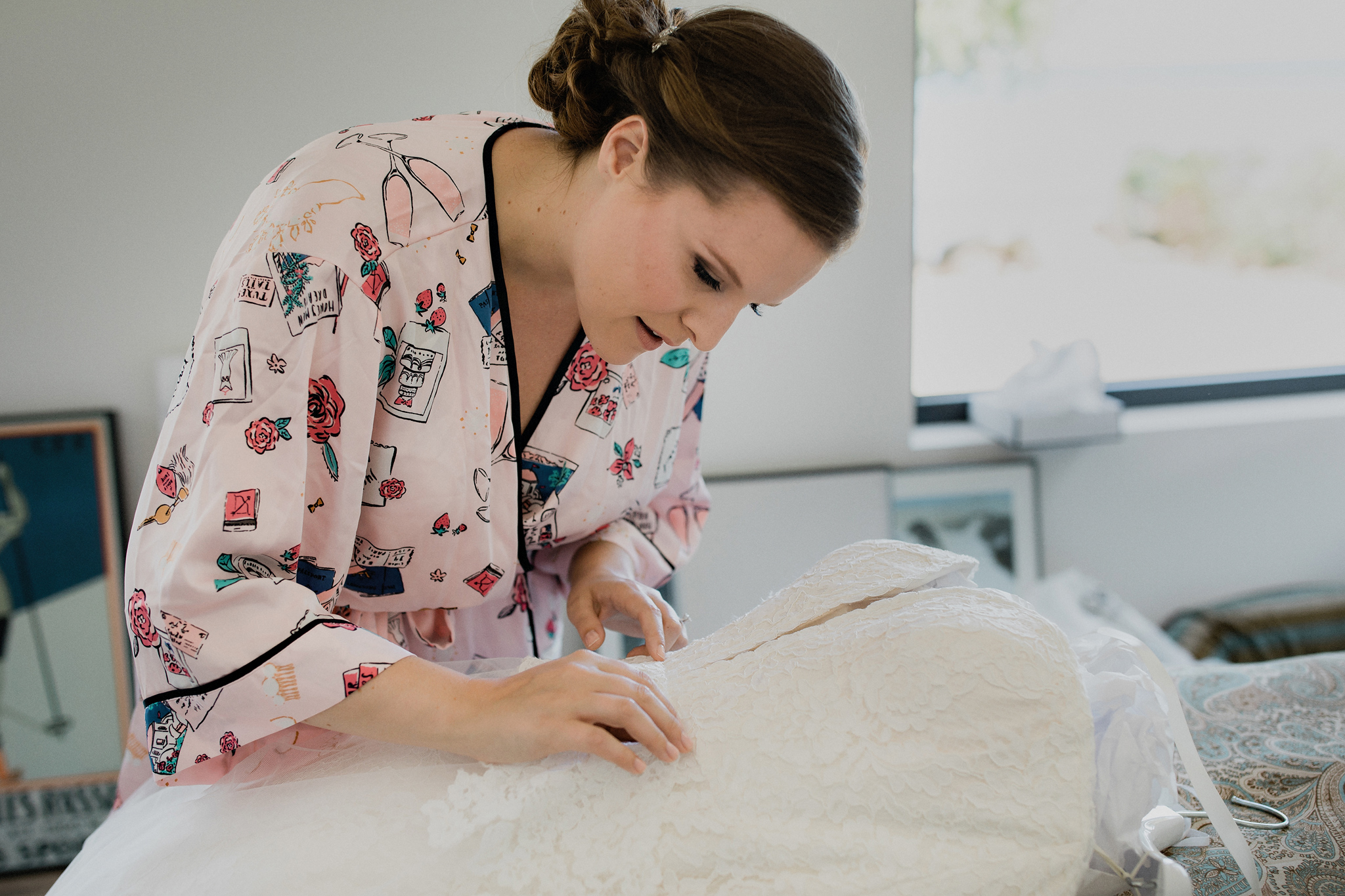 bride inspects her beautiful wedding dress