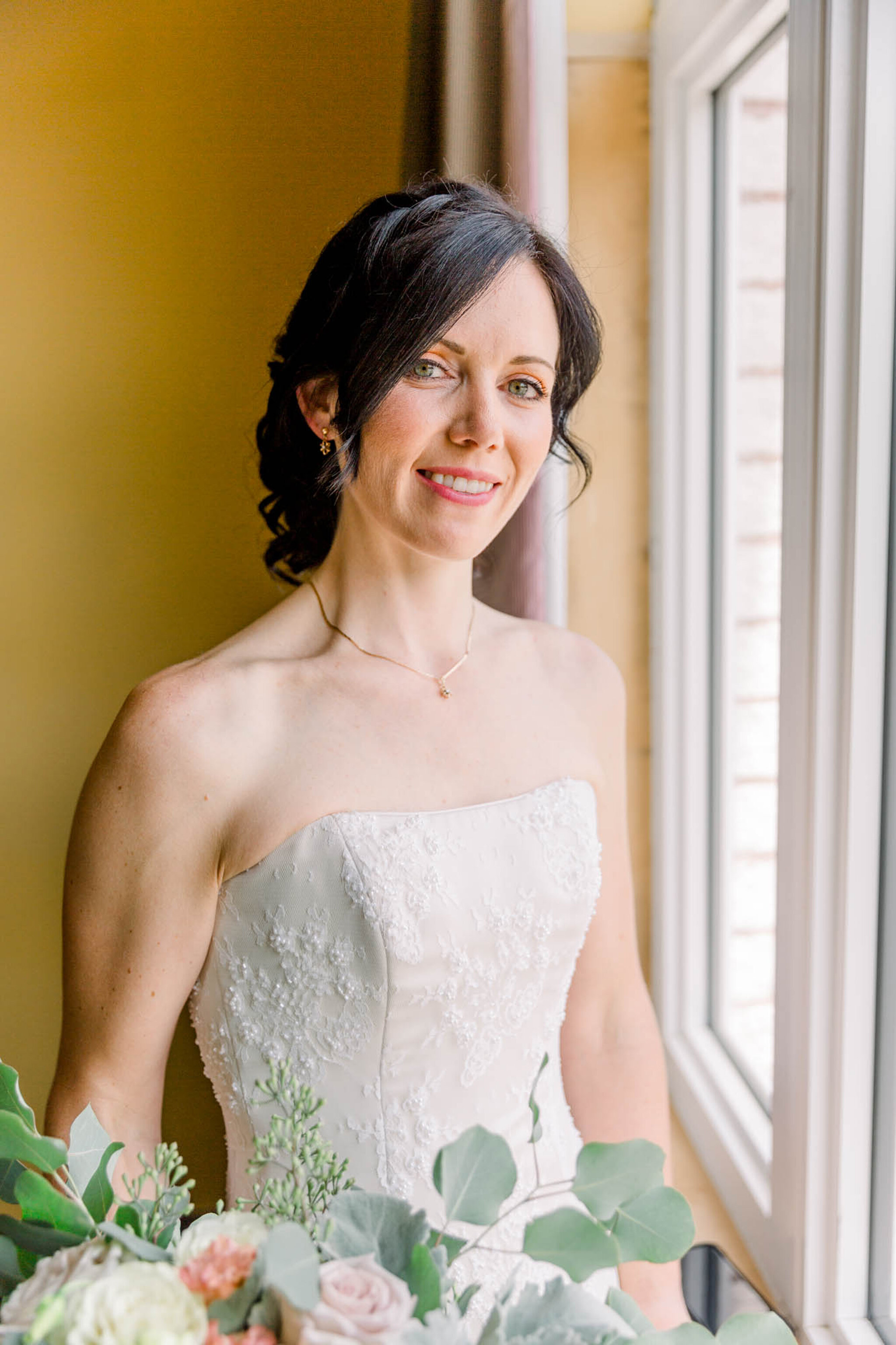 Bride standing in the window of the Bridal suite at Walters Fall