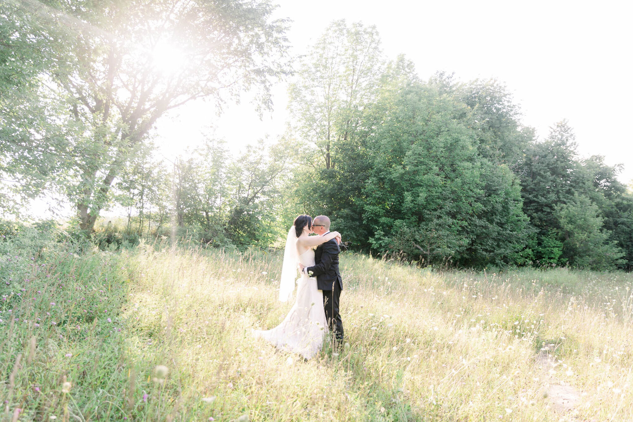 Wedding portraits in the field at Walters Falls Inn and Spa