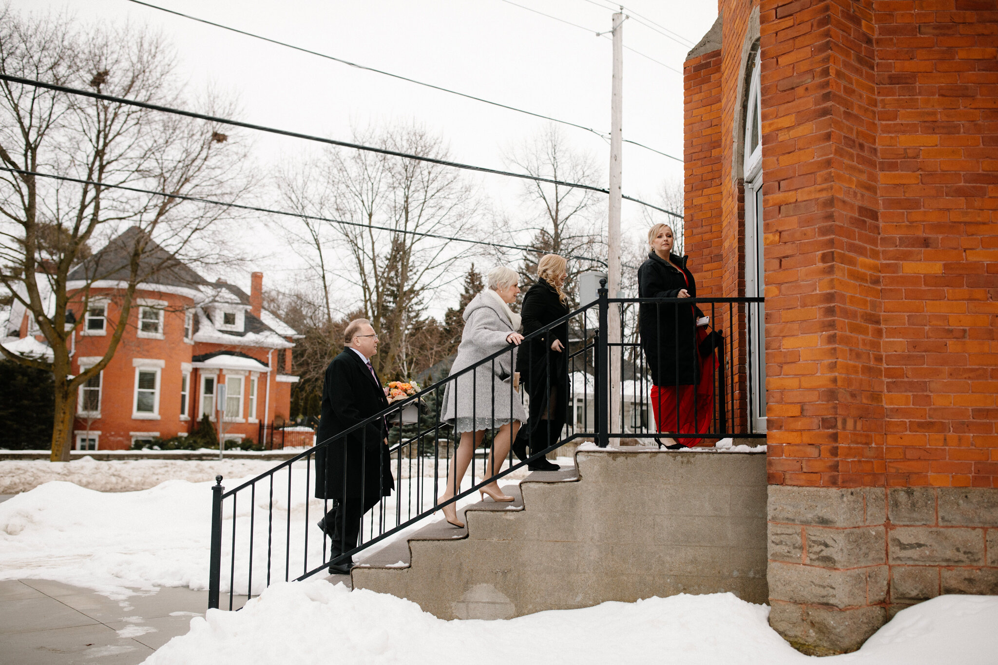 guests arriving at thornbury church for winter wedding