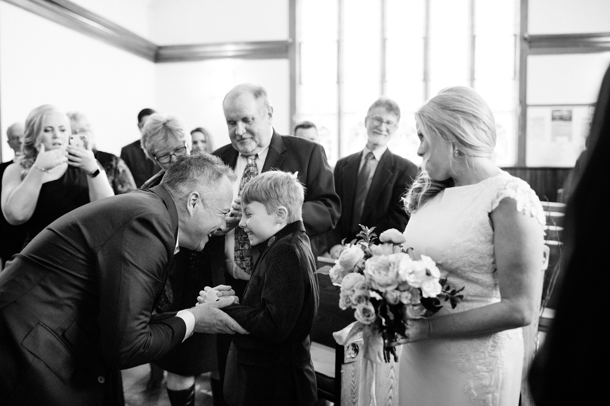 Groom greets his son at Thornbury winter wedding