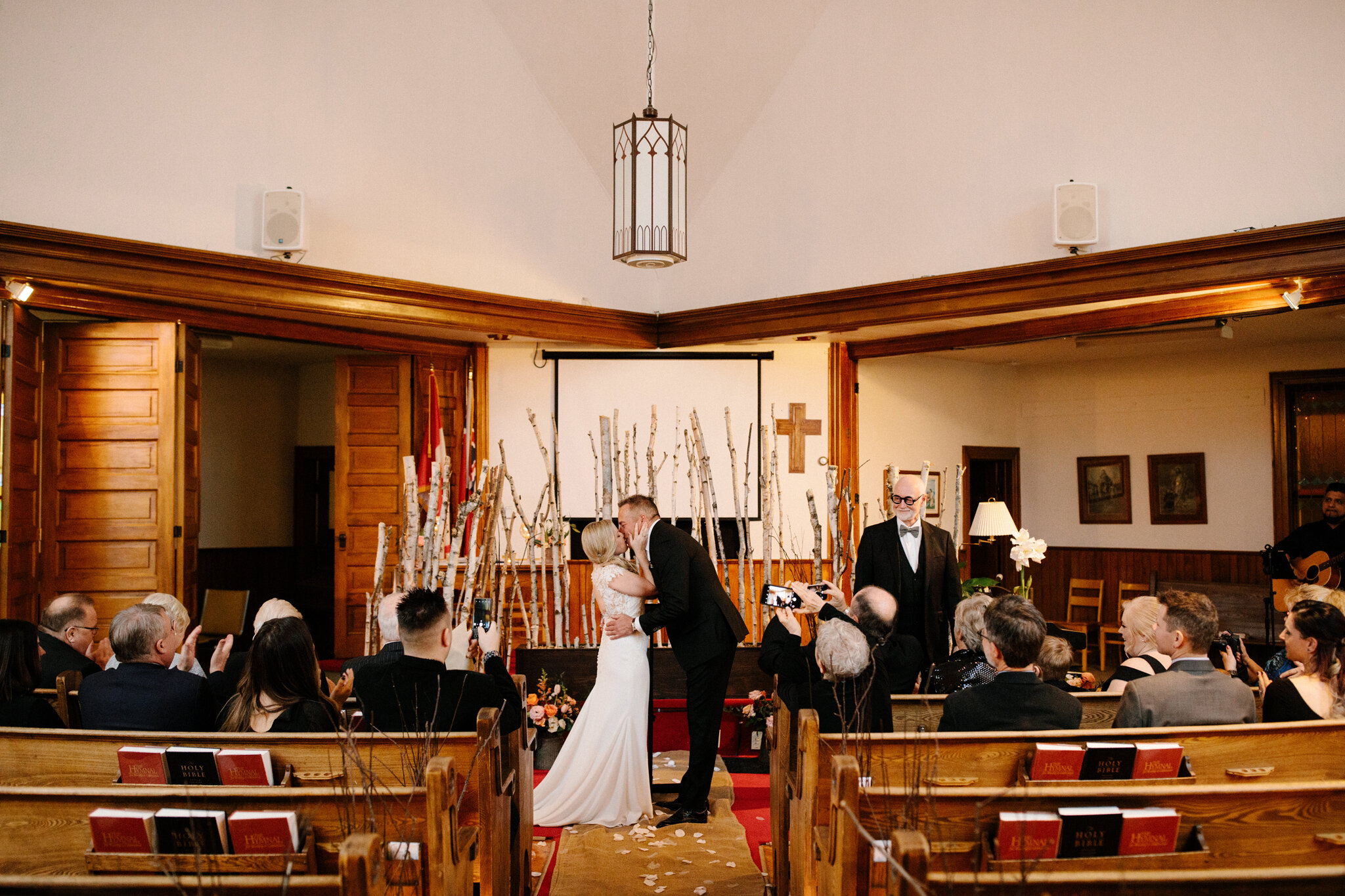 First kiss in church at intimate winter wedding