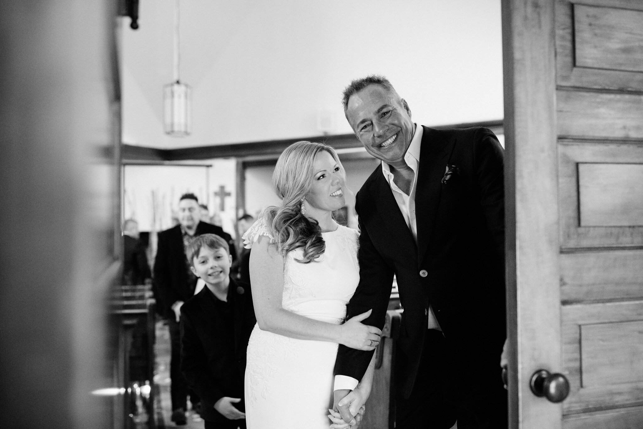 Just married couple exit church at intimate winter wedding in th