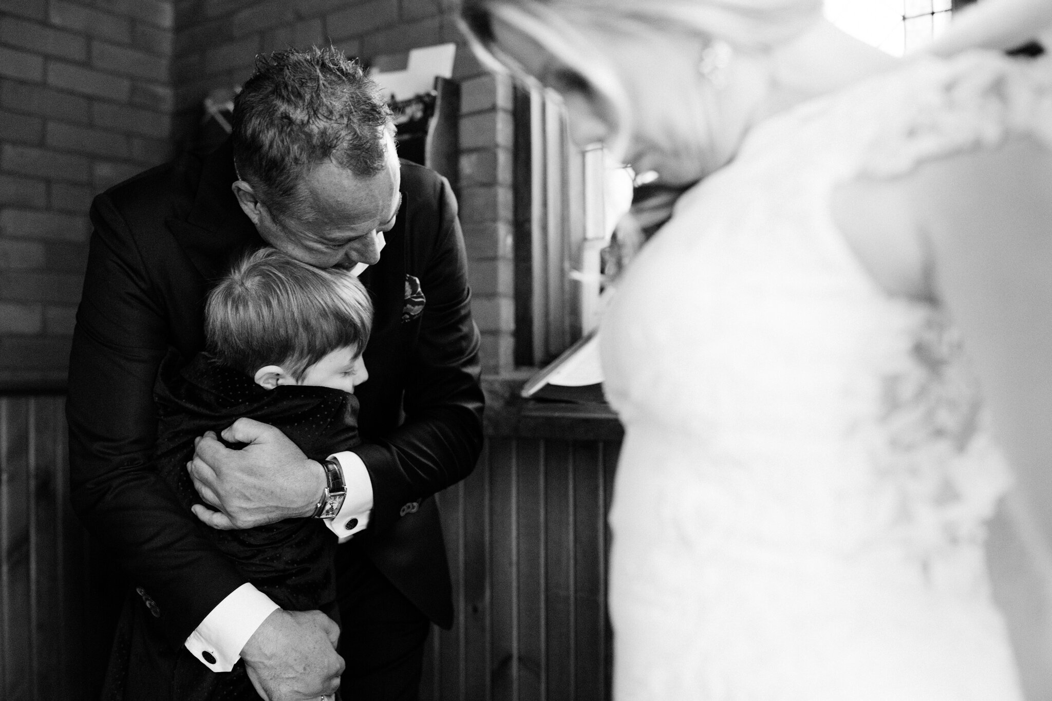 groom hugging his son after wedding in Thornbury Ontario