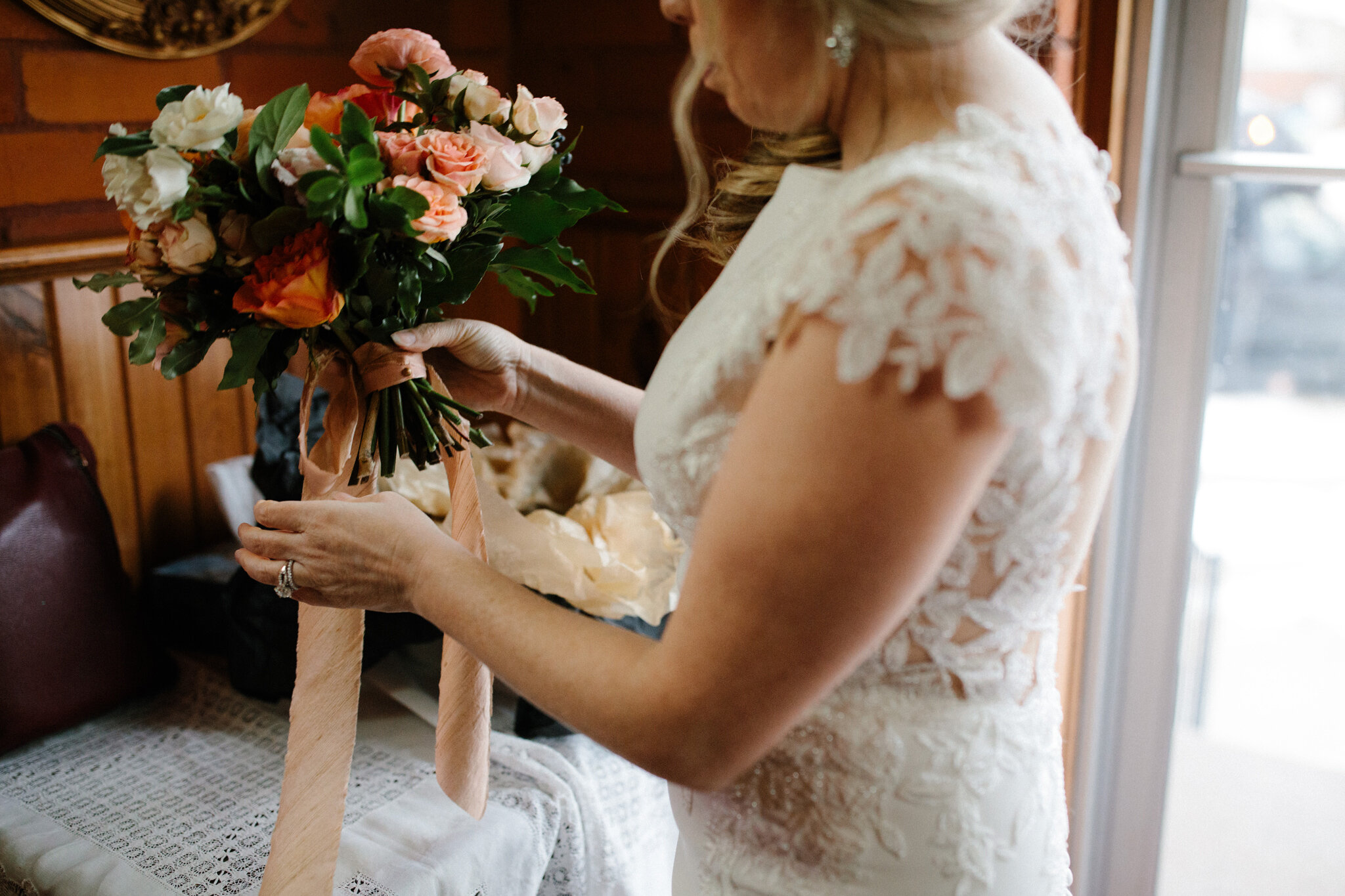 bride holding coral wedding bouquet