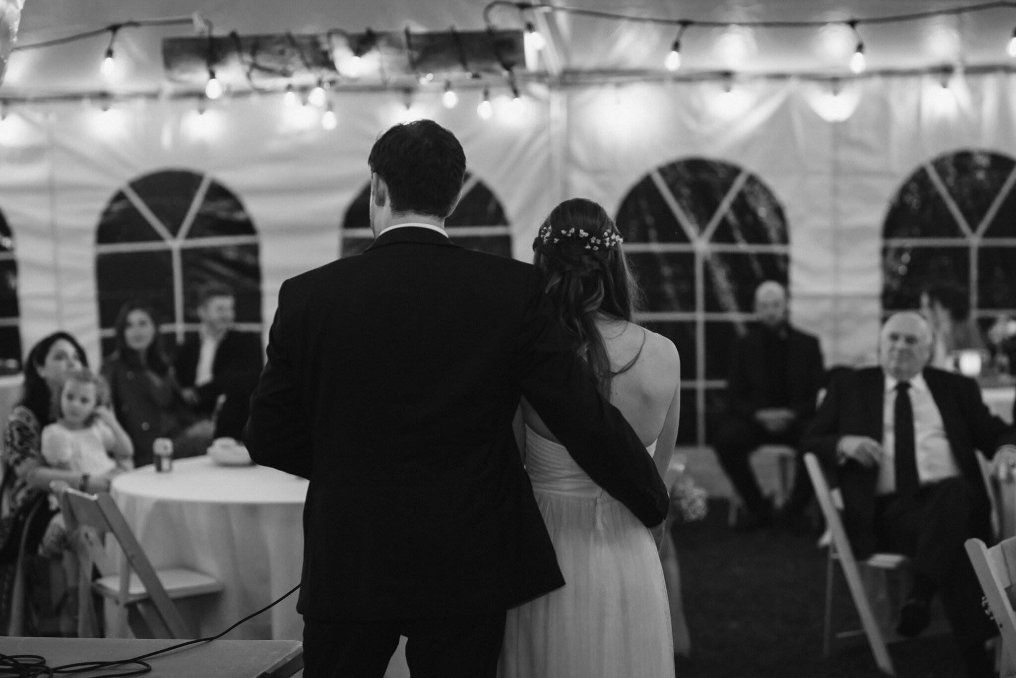 Newlyweds speech in tent with string lights in south georgian ba