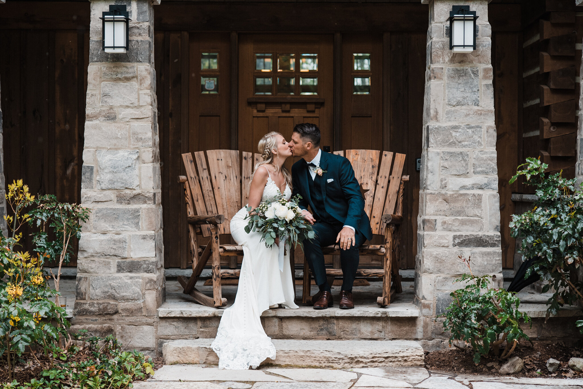 Romantic wedding kiss in front of Serenity Cottage