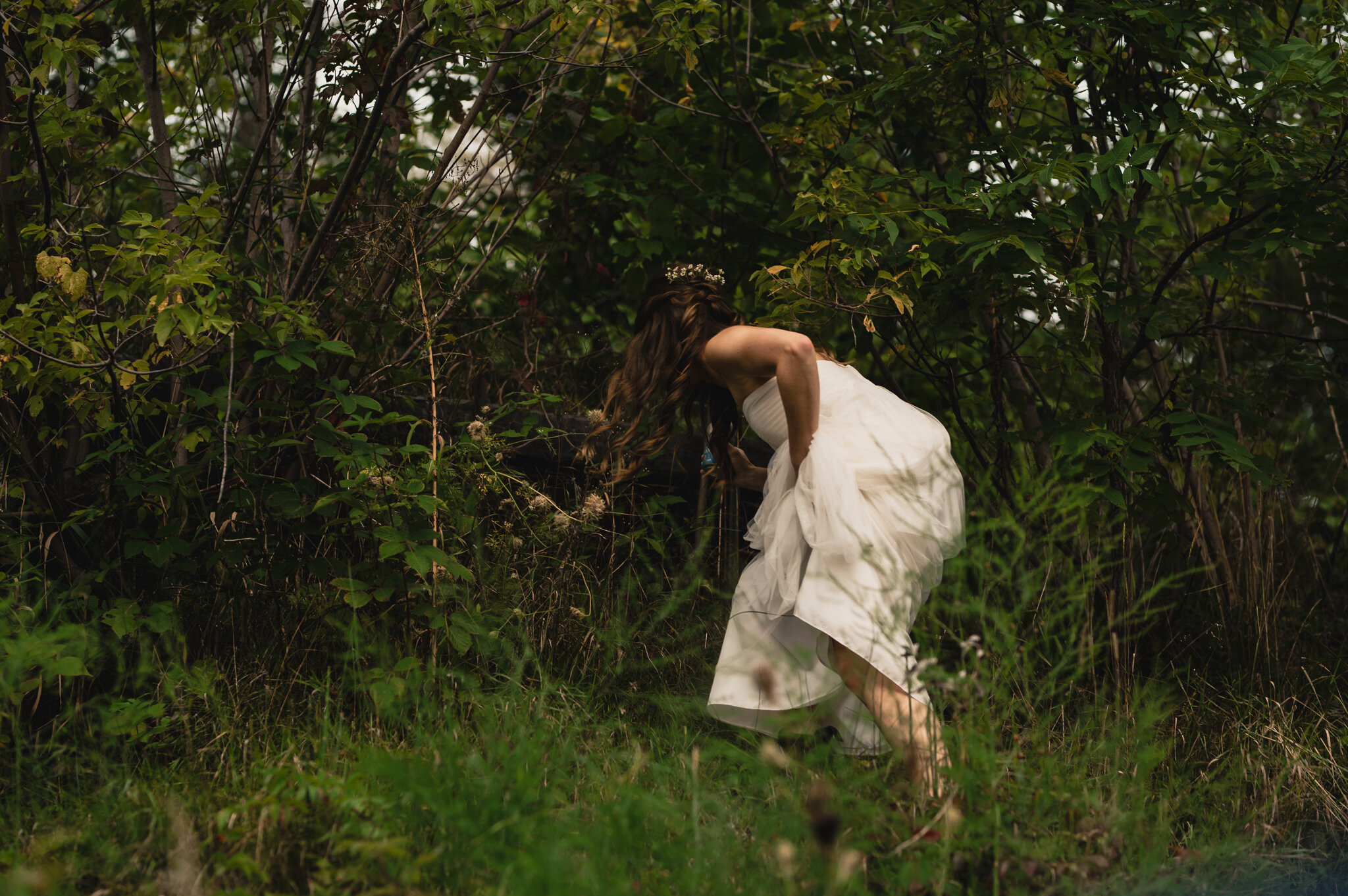 Bride adventuring in the forest by Jessica Crandlemire