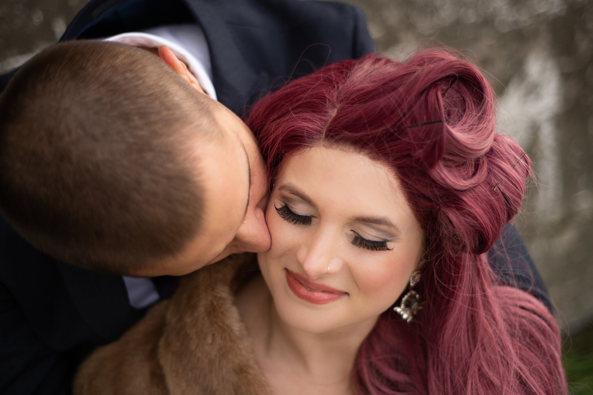 Modern Collingwood elopement couple kiss with fur stole and pink
