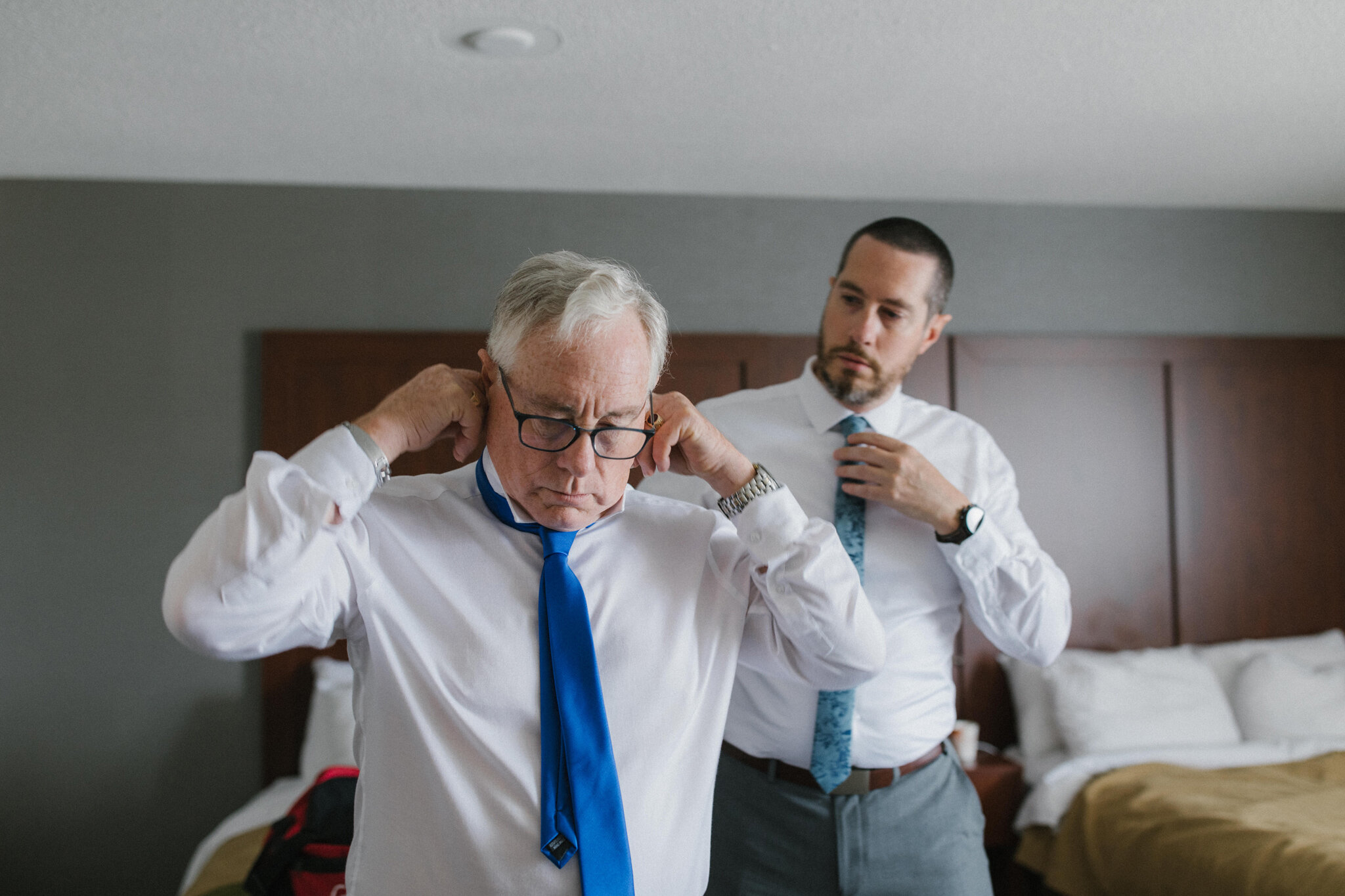 Father of the groom and brother getting ready together