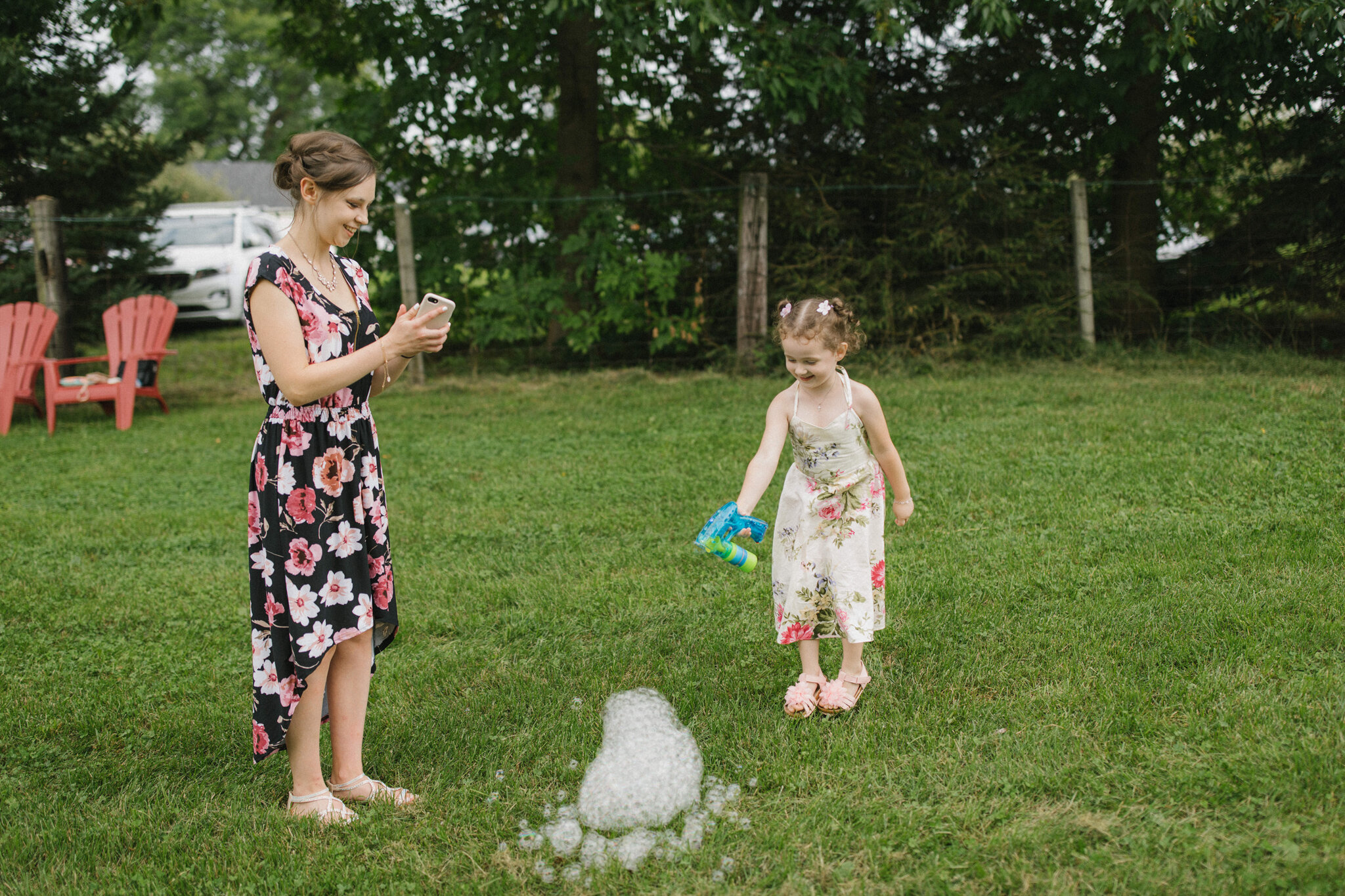 flower girl plays with bubbles
