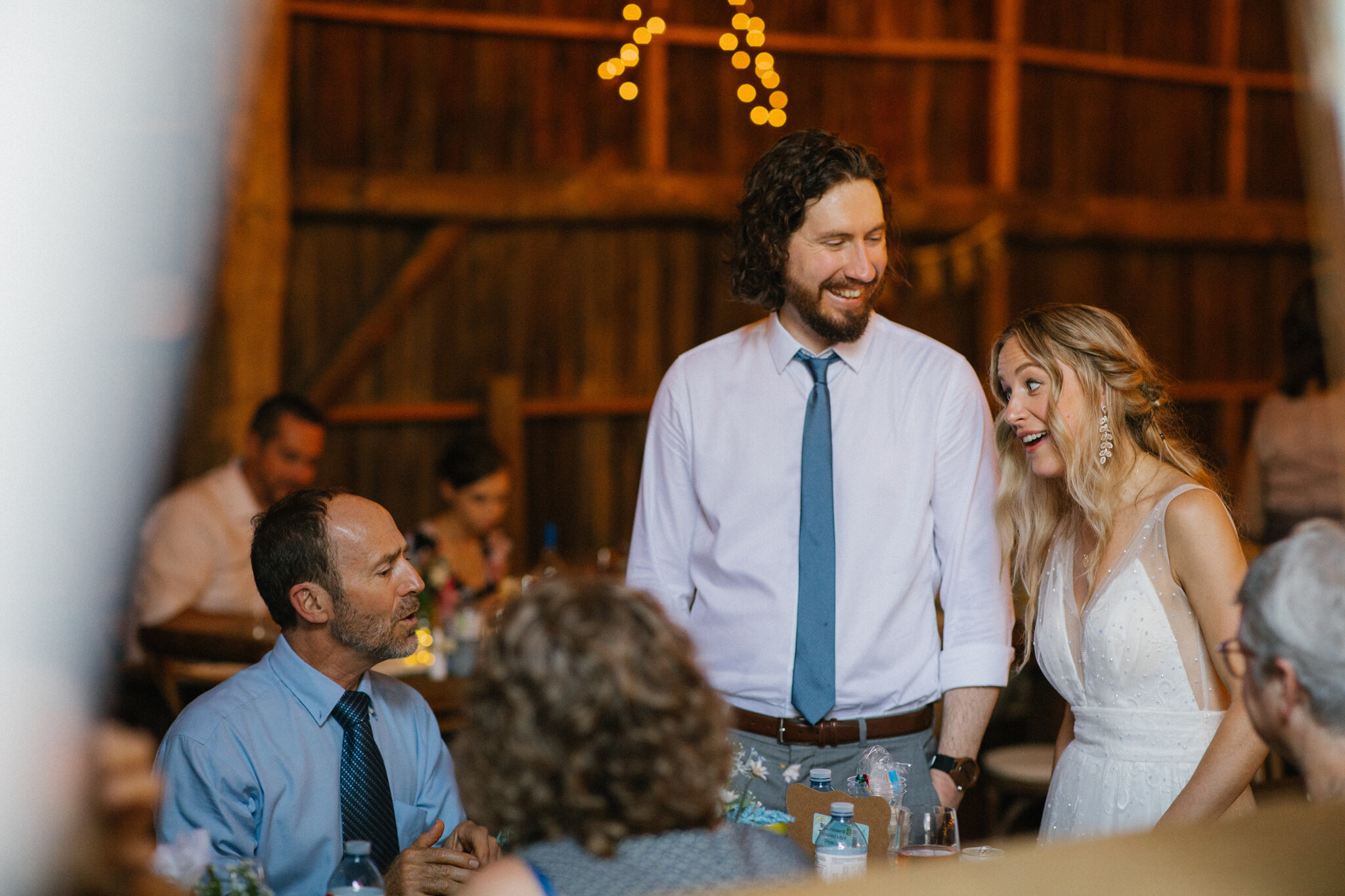 couple mingle tables barn wedding