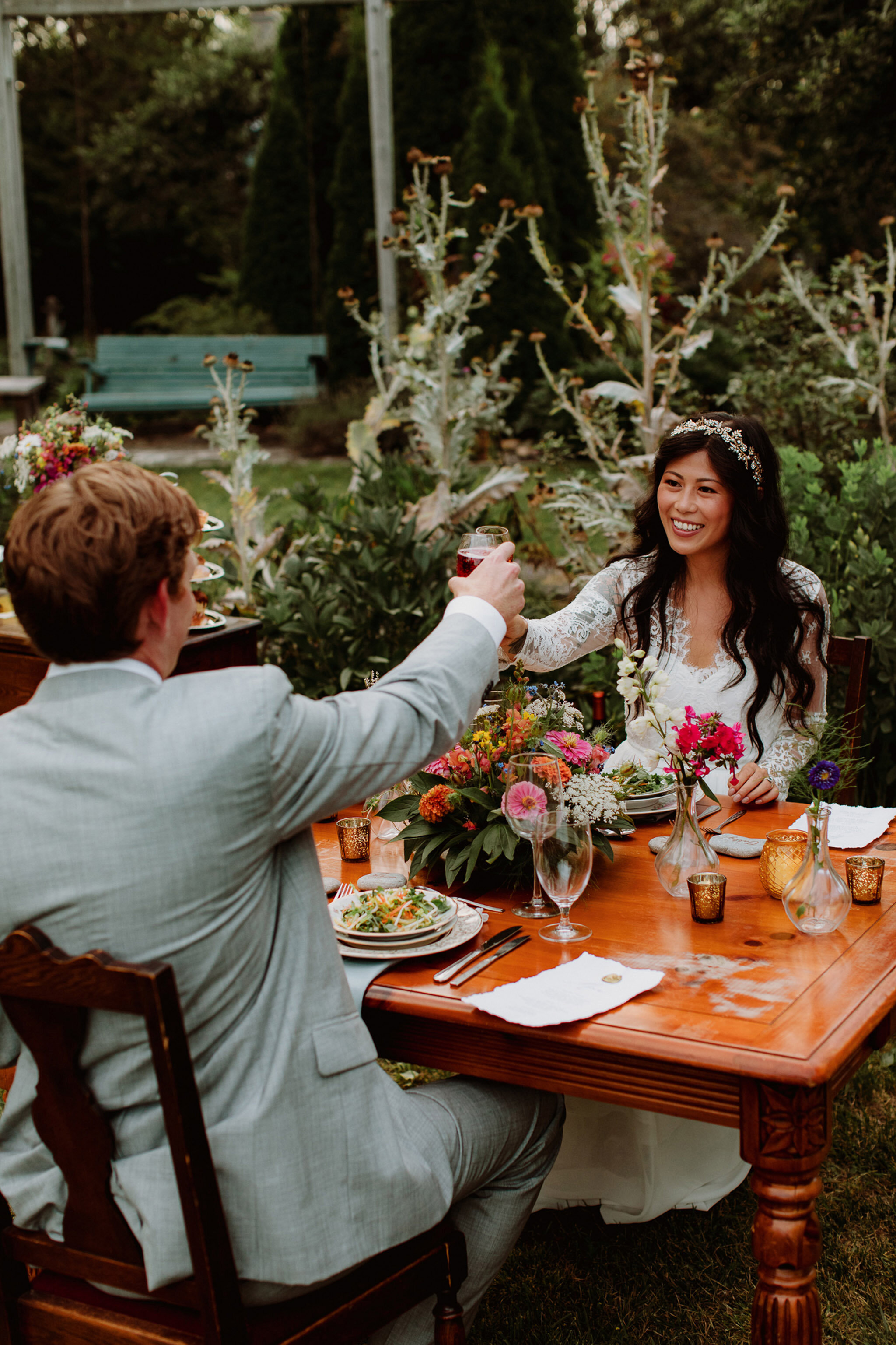 couple share toast at outdoor elopement dinner