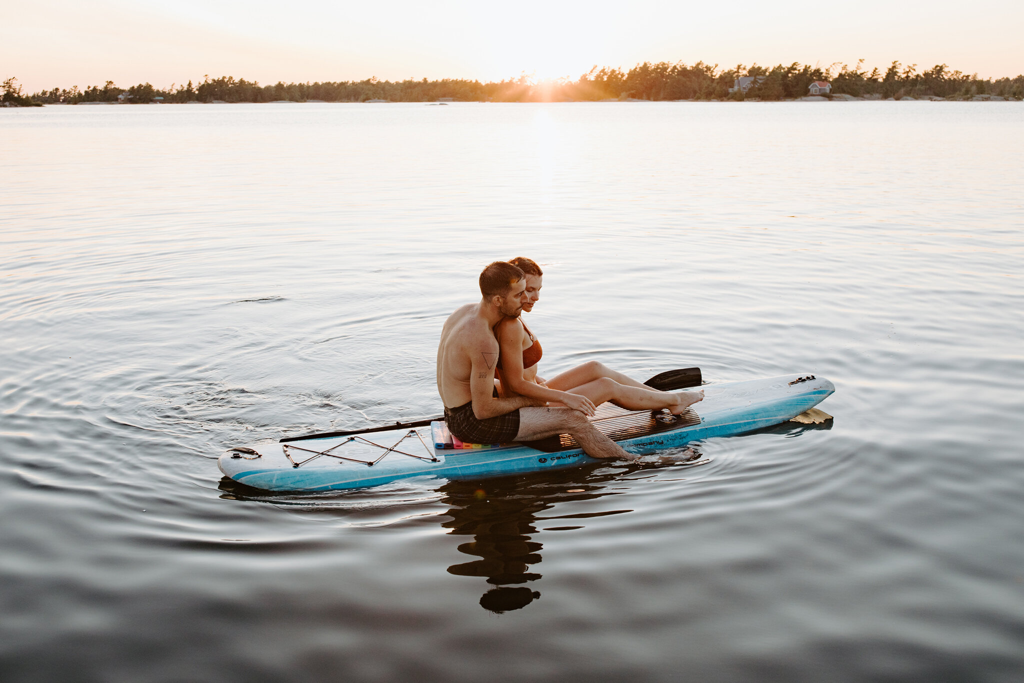 georgian bay romantic couple paddle board at sunset