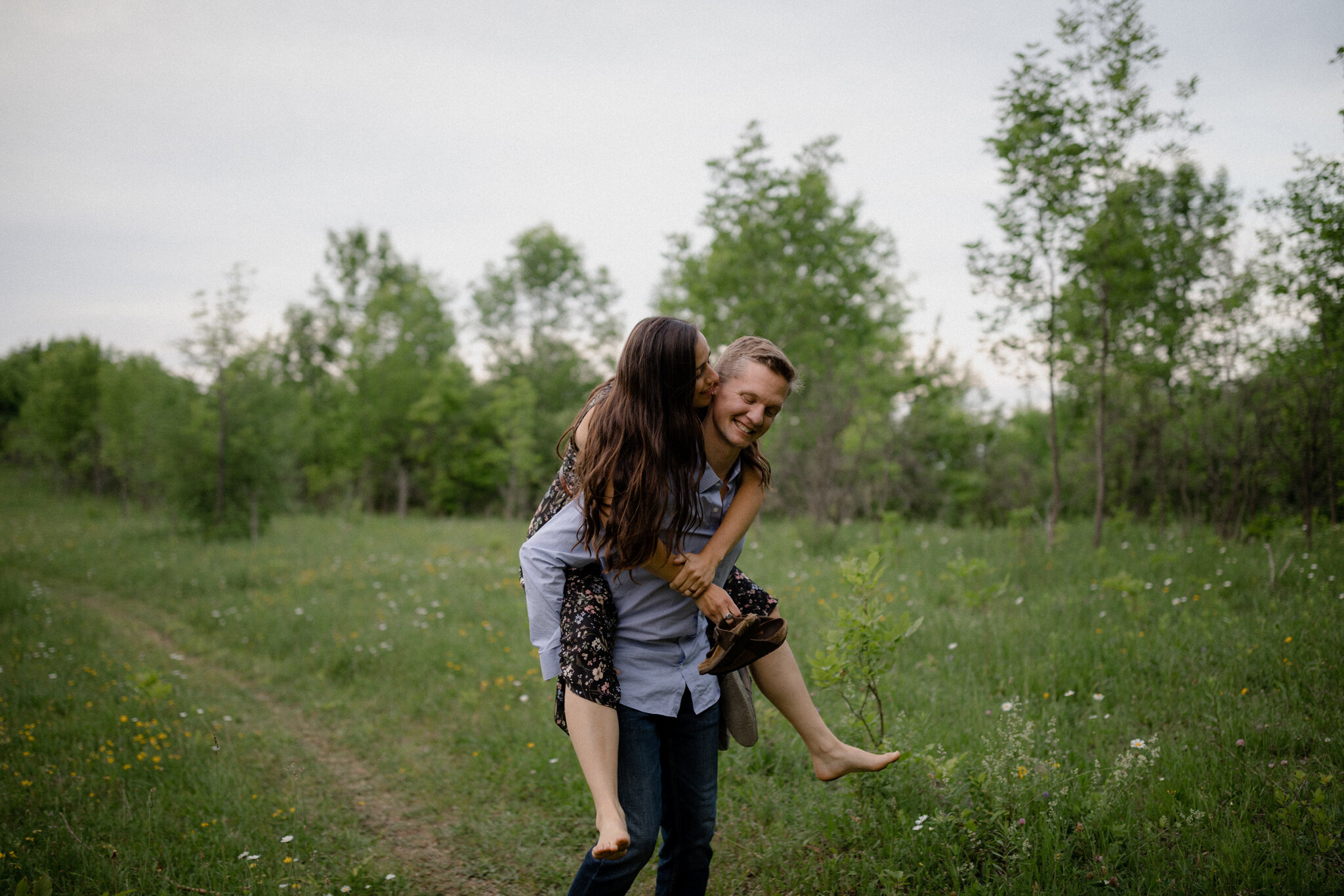 playful piggyback during engagement session in Beaver Valley