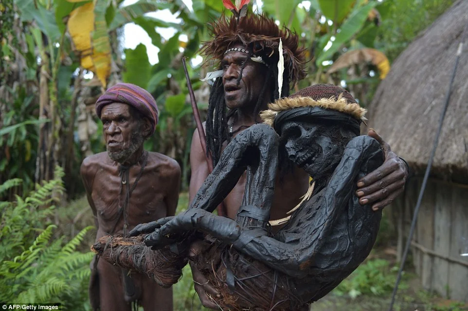 Dani tribe chief carrying smoke-preserved ancestor. The Dani live in a remote area of the Papuan central highlands. Photo: Getty.