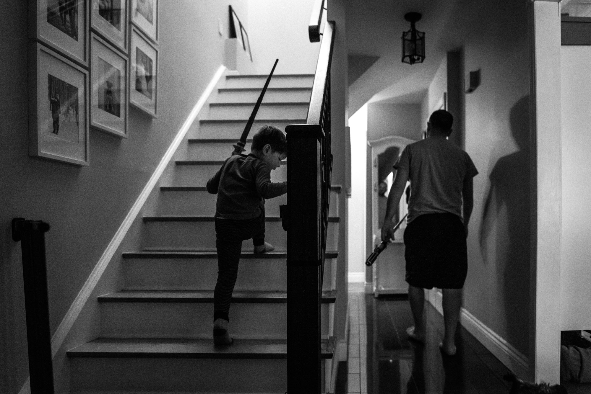 boy climbs the stairs as dad walks away