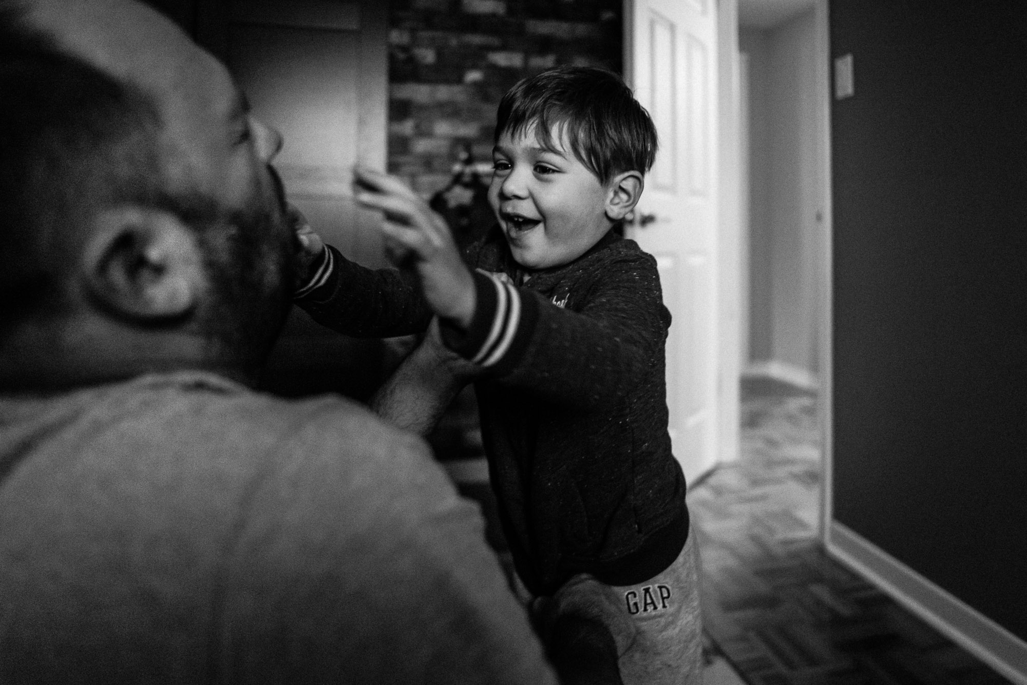 boy approaches dad with a big smile