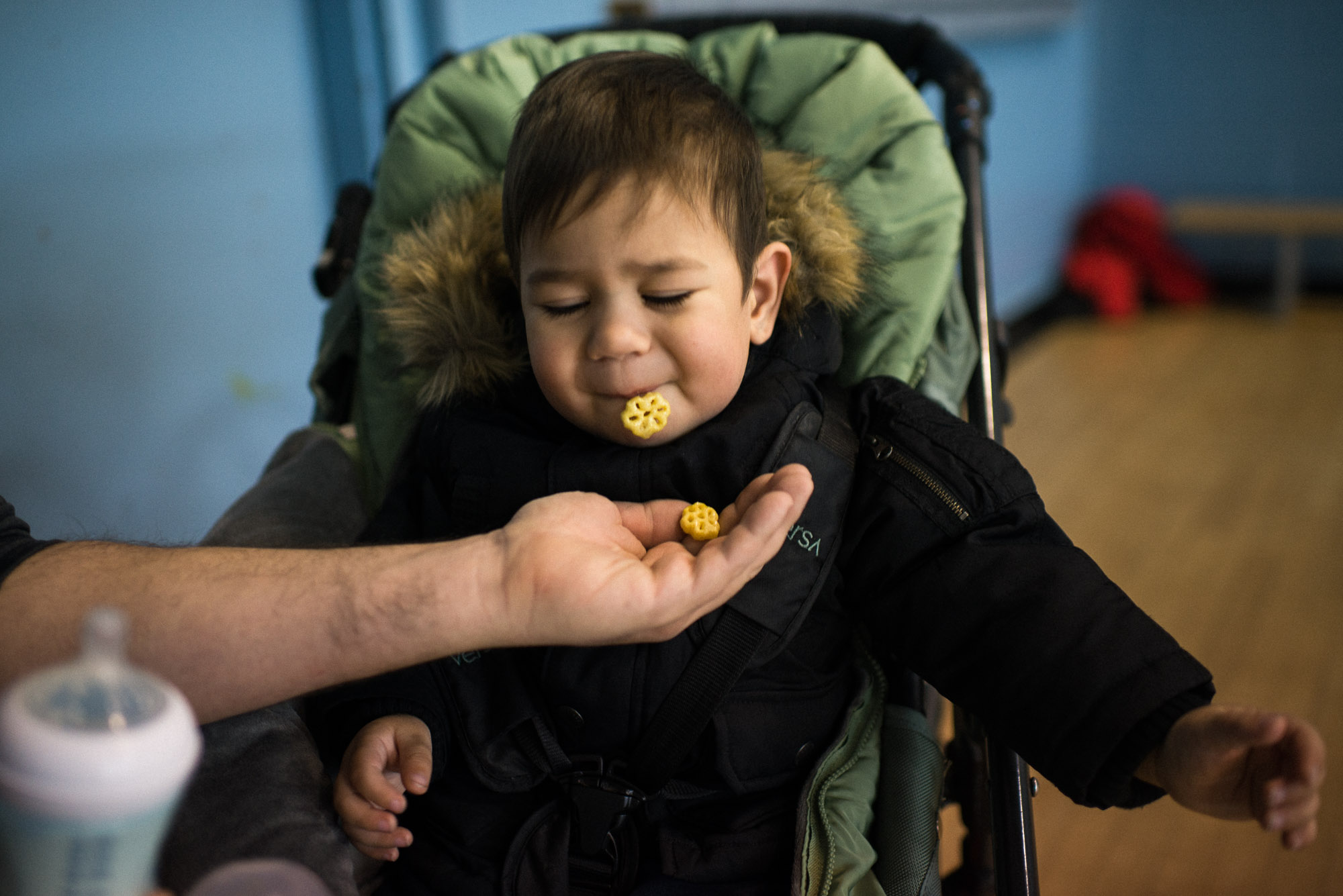 toddler spits out snack into dad's hand