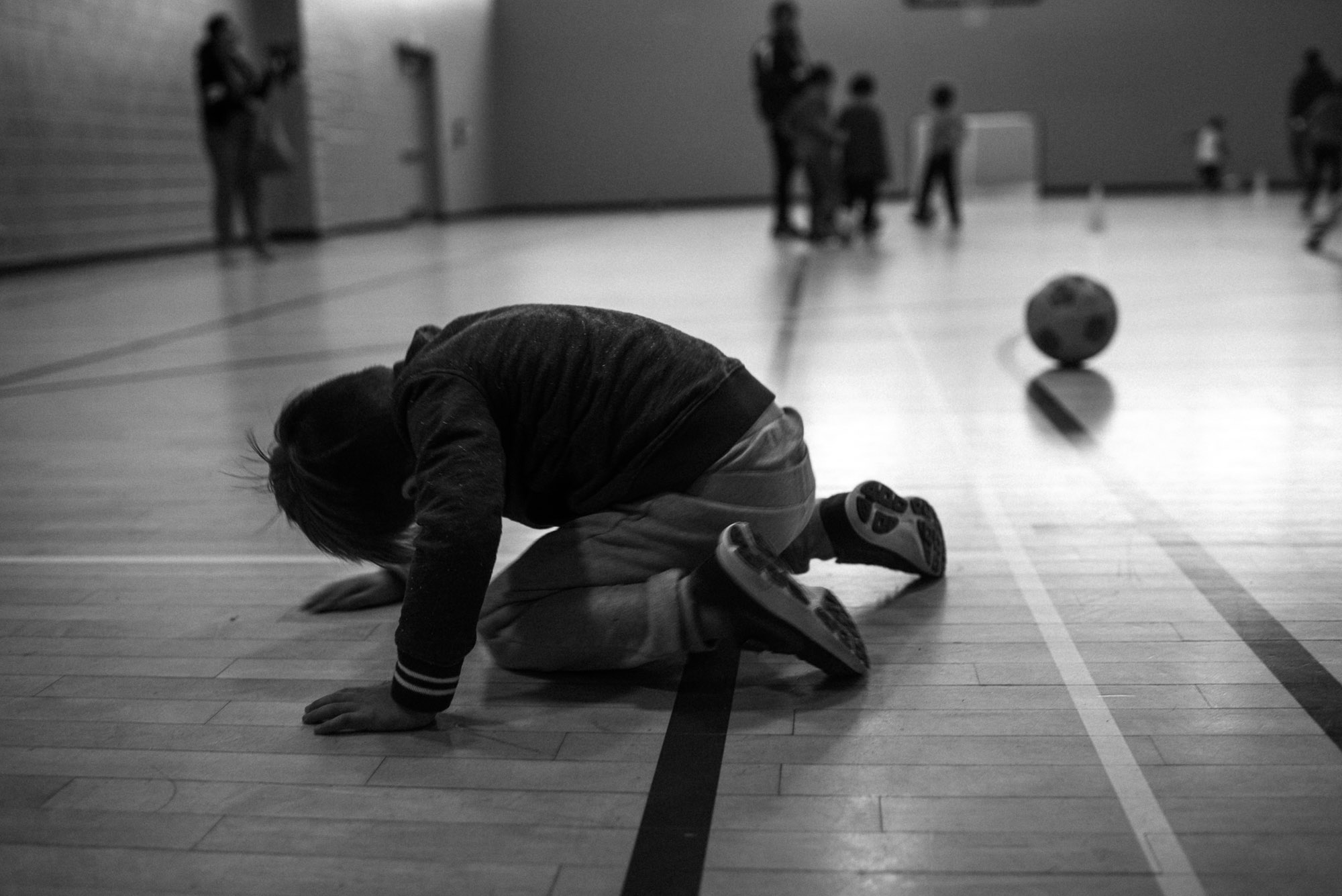boy reclines on the floor at soccer practice