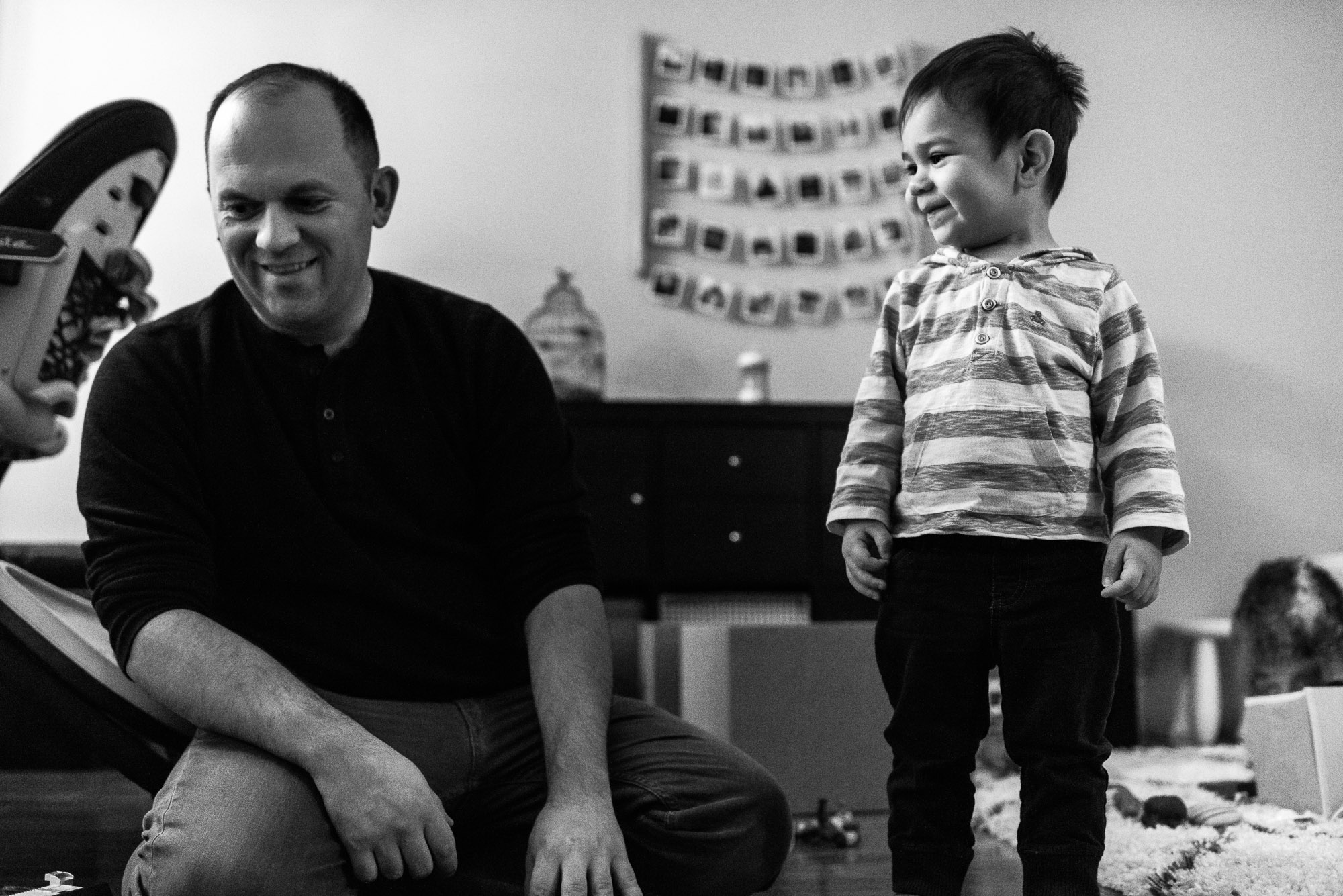 toddler smiles next to dad
