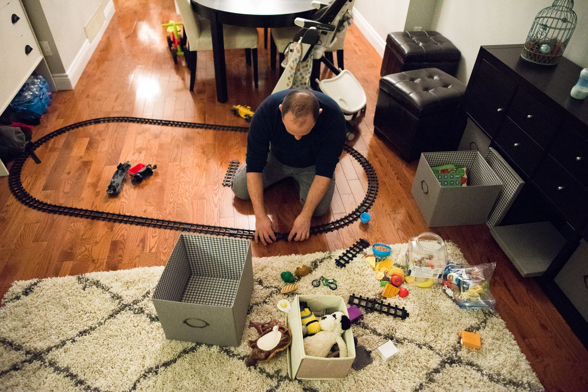 dad plays with a train set