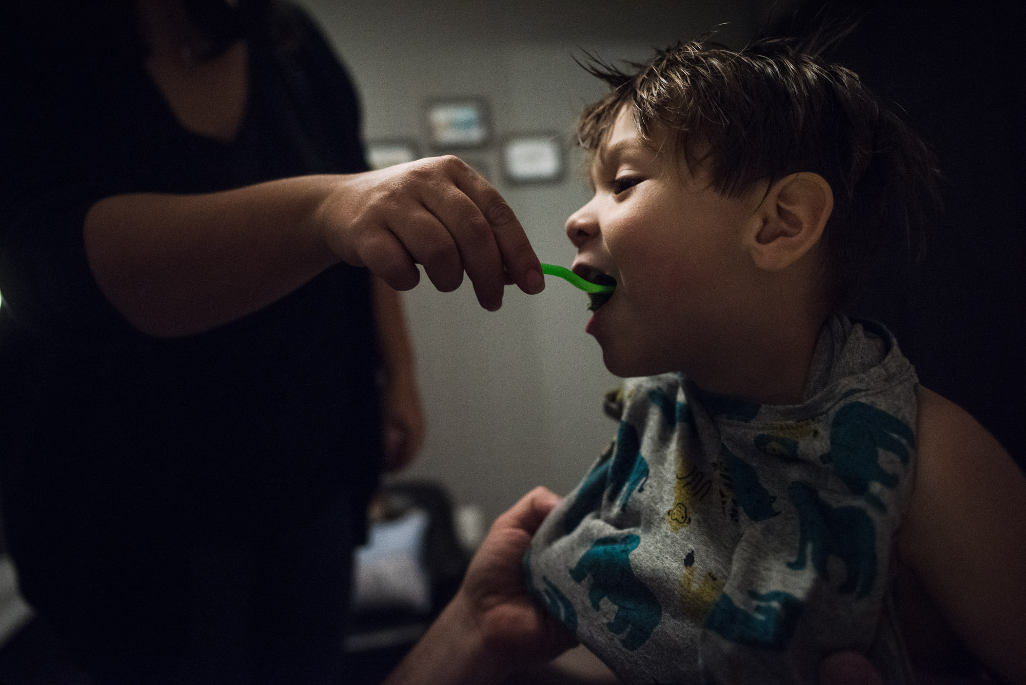 mom brushes boy's teeth