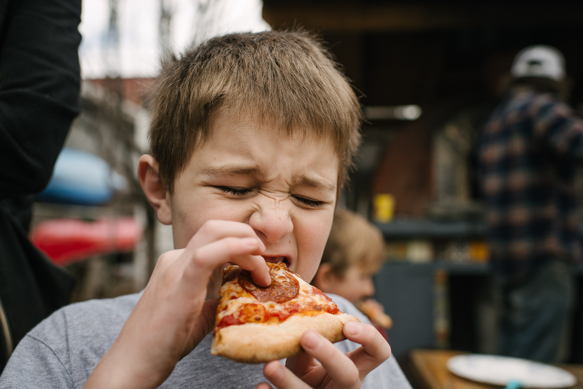 boy eats pizza