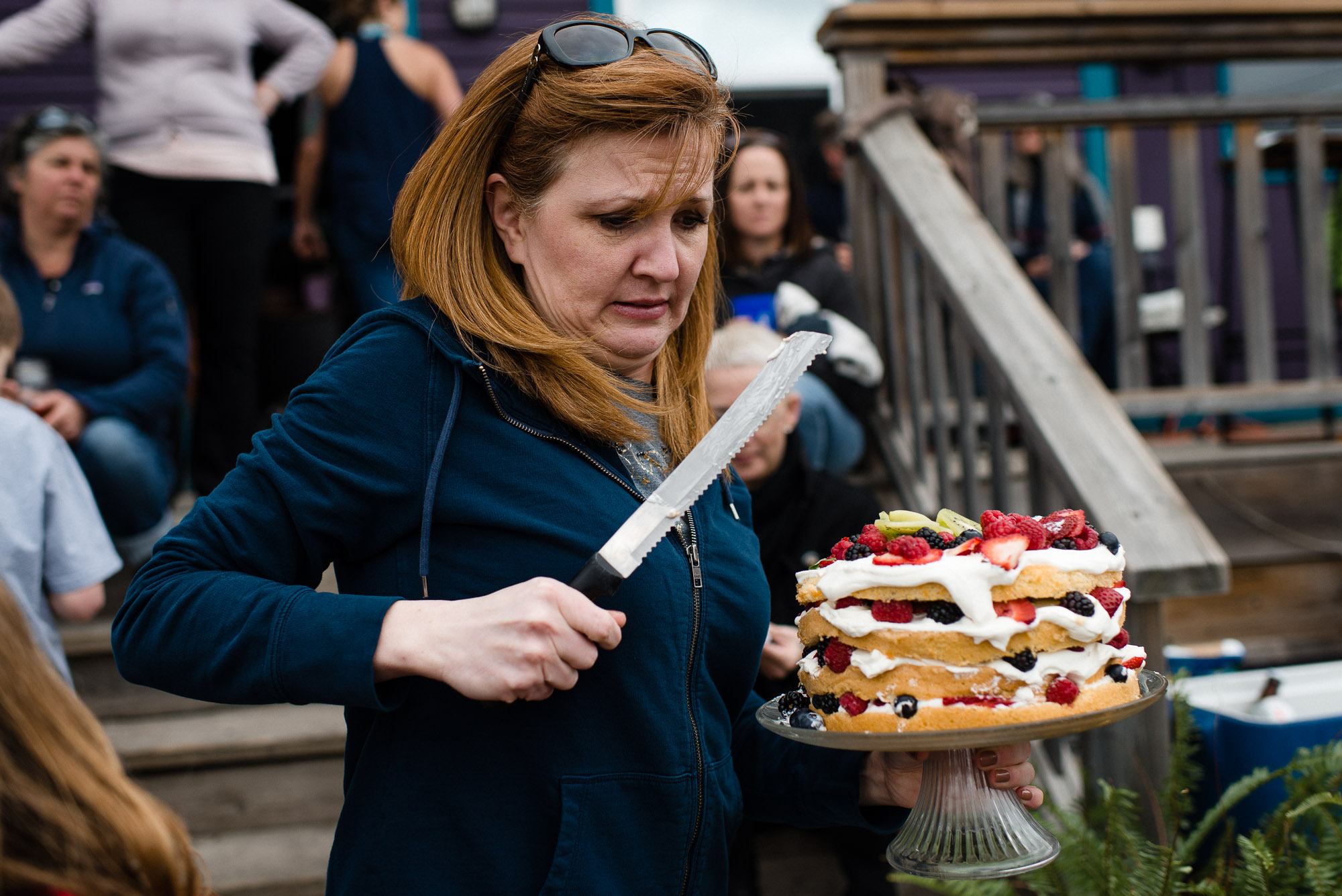 woman carries cake and knife