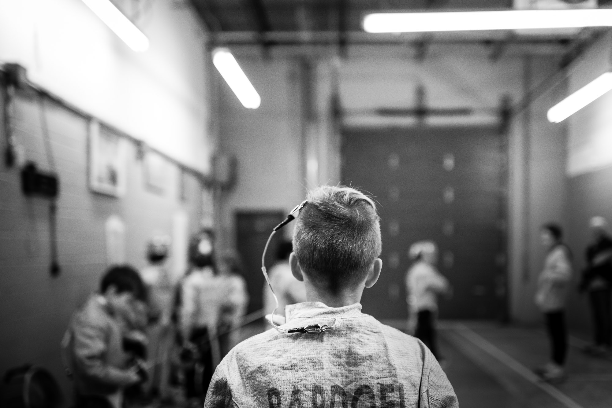 back of boy, in fencing outfit