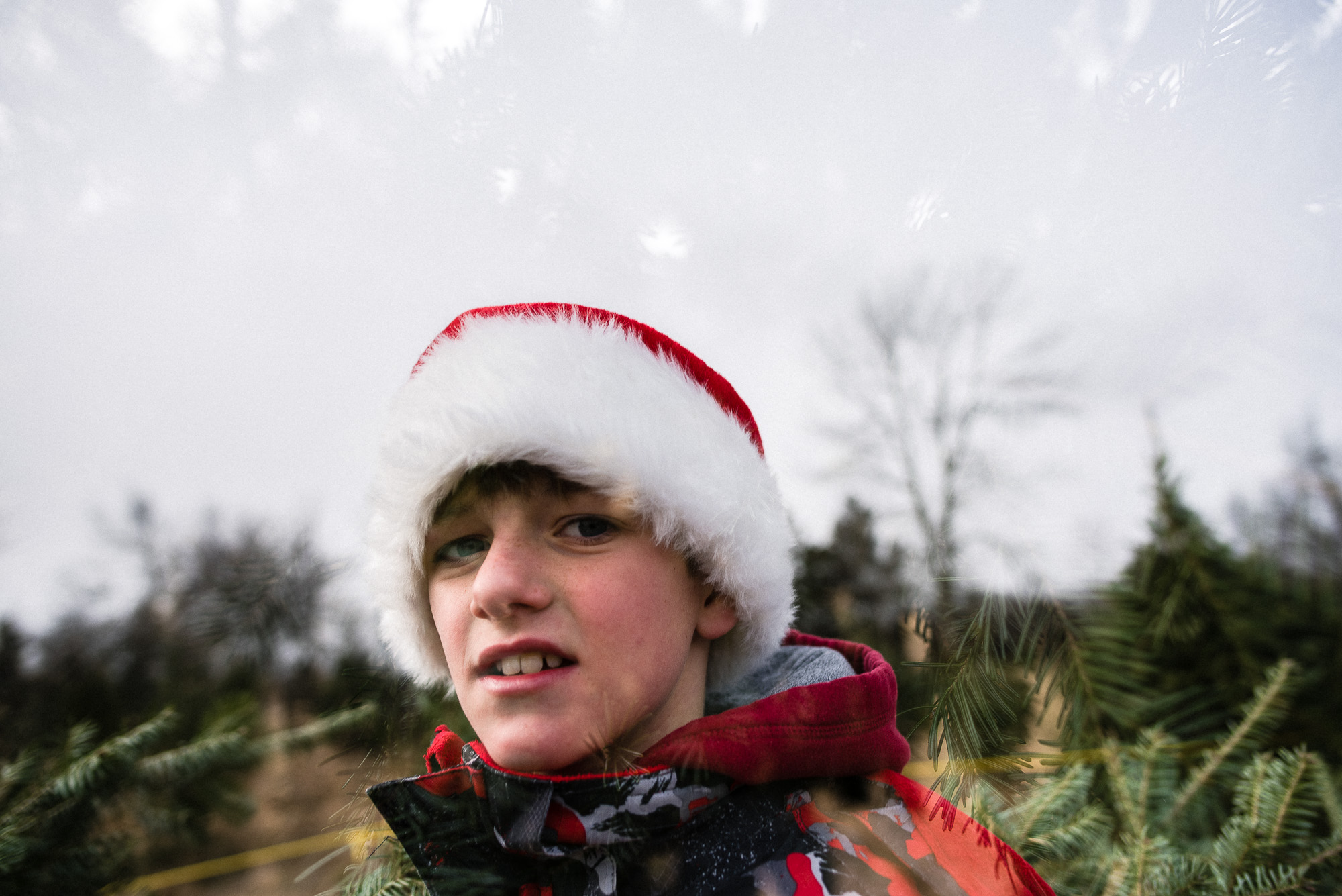 double exposure of a boy in a Santa hat