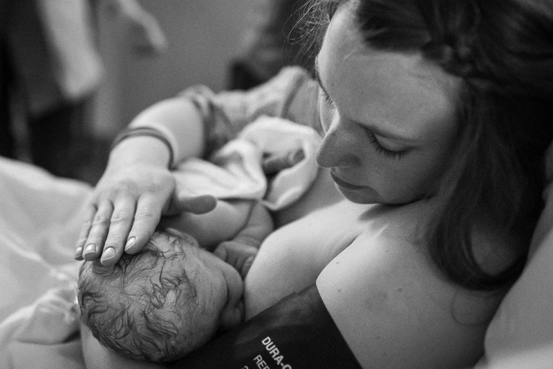 mother breastfeeds baby after giving birth