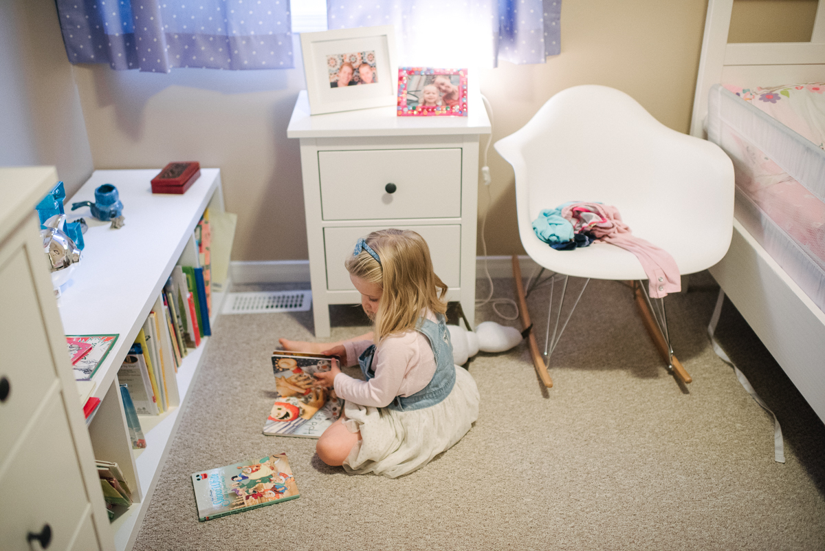 Girl reading a book in her room