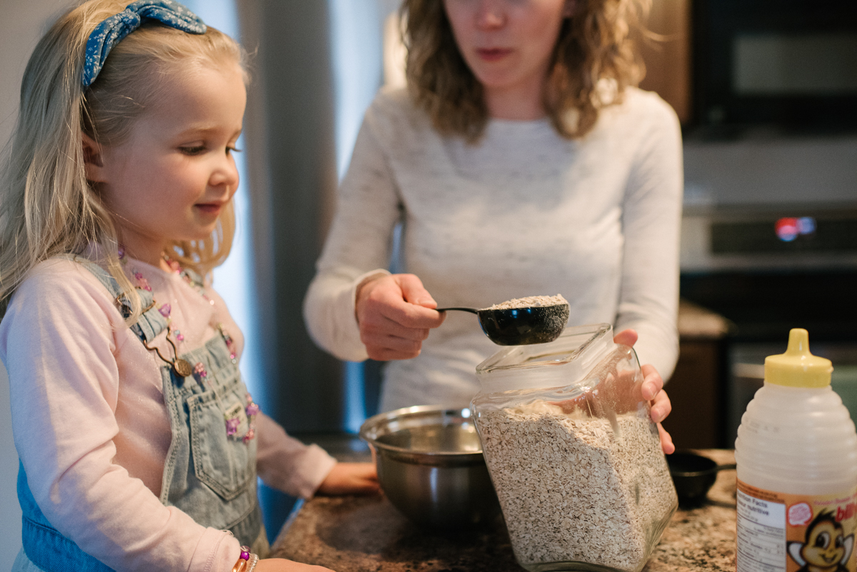 Mother and daughter cooking food in the kitchen