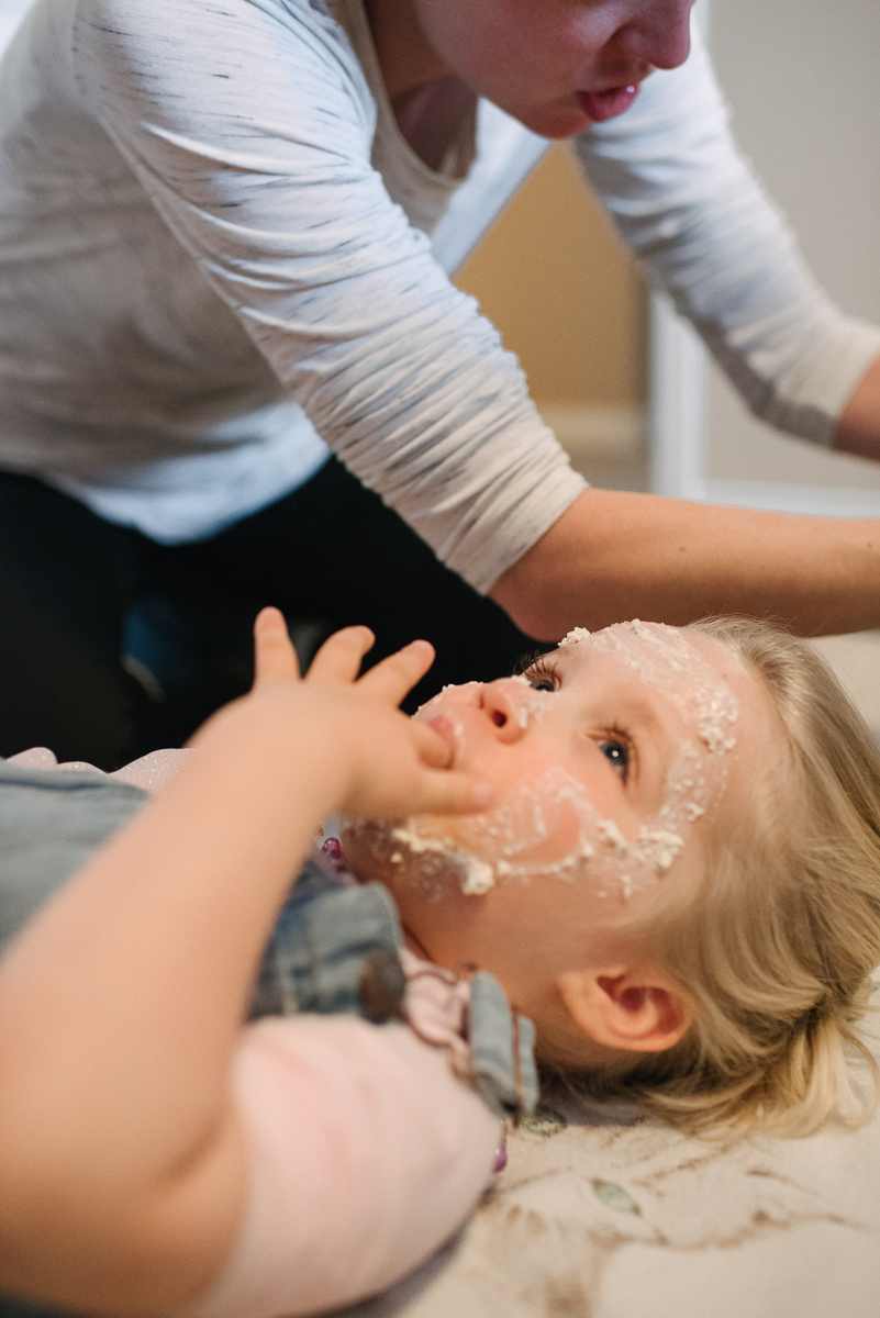 Daughter getting face treatment from mother