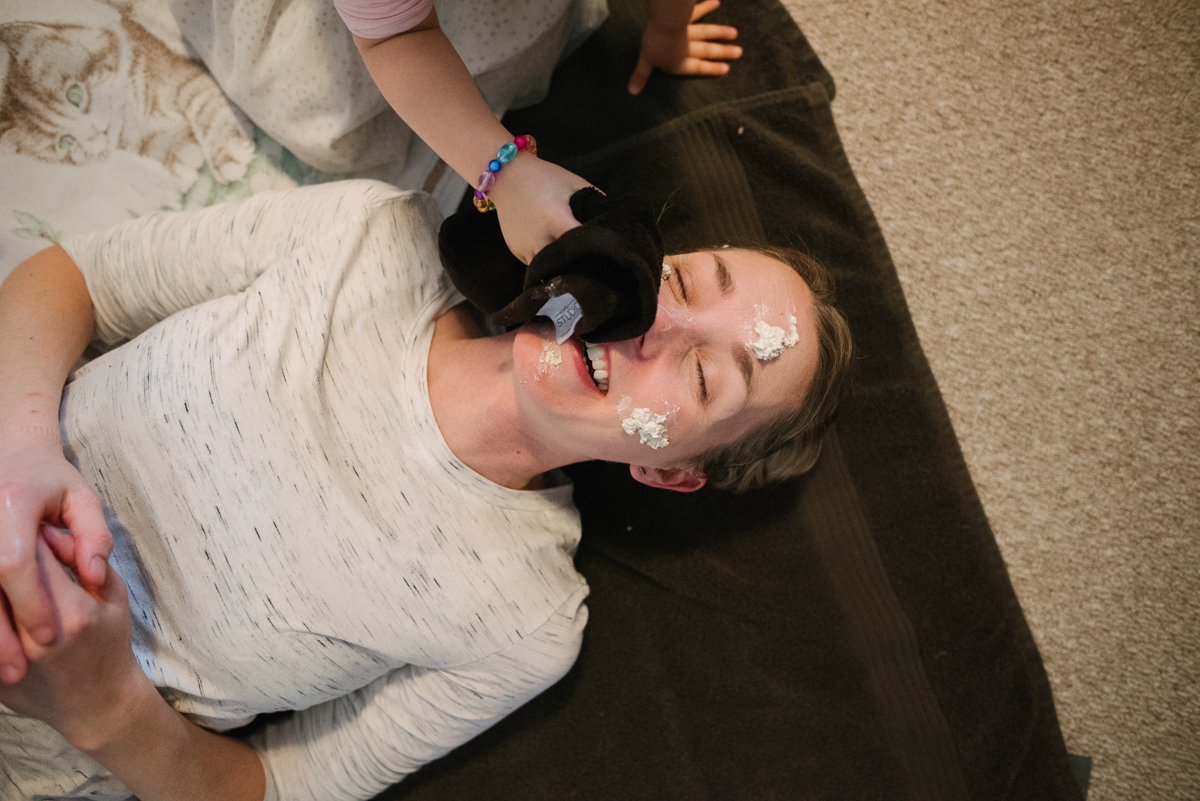 Mother getting face treatment from daughter