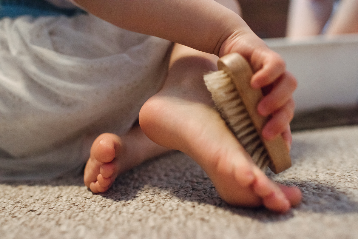 Girl brushing her feet