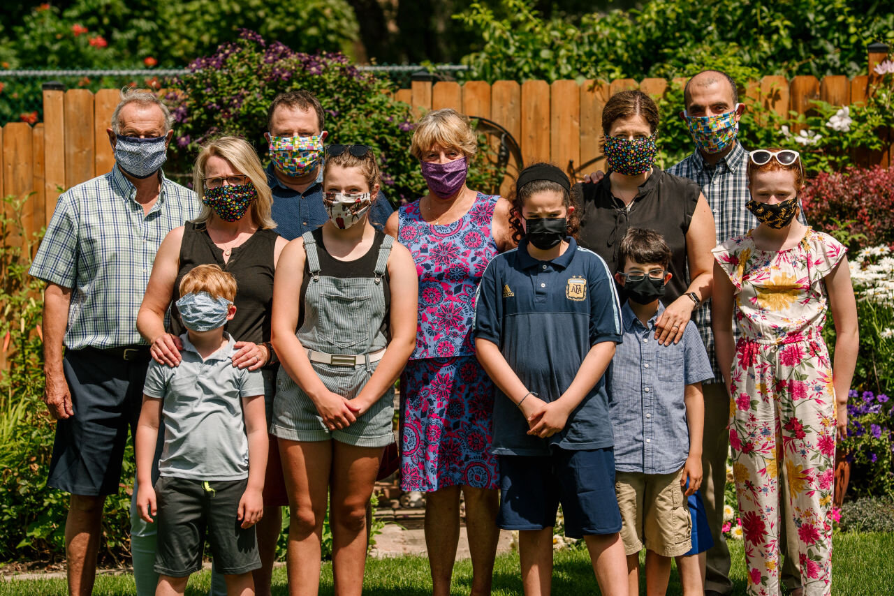 Family portrait wearing COVID19 masks during family photography session 