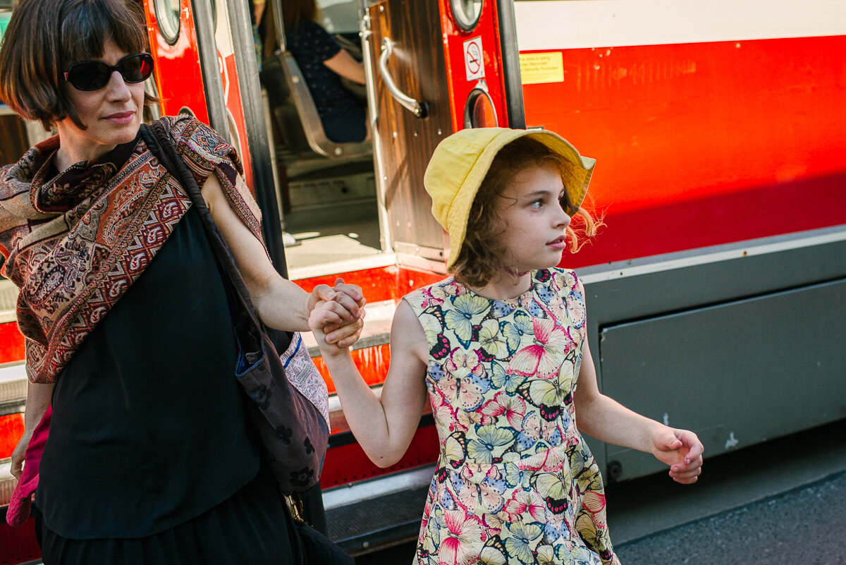 Mother and daughter get of street car in Toronto 