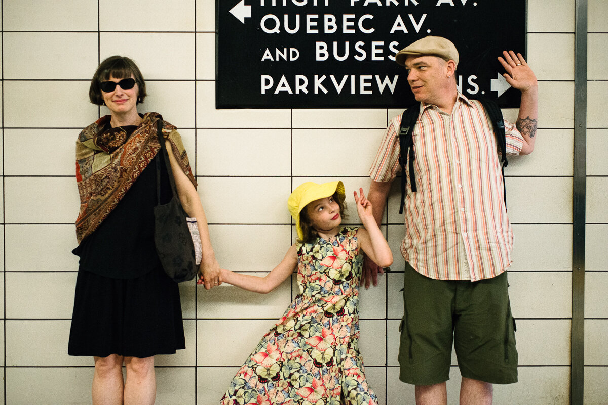 family of three poses in the subway station in Toronto Ontario 