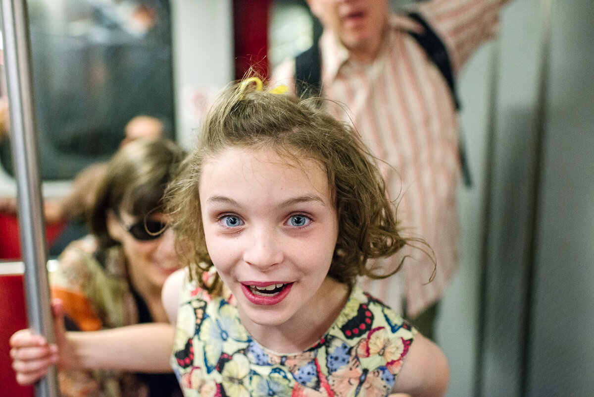 excited and happy girl riding in the subway 