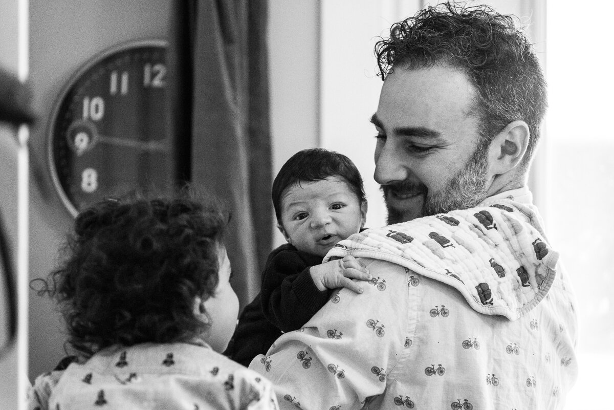 Father and his sons cuddling during family session in Kingston 