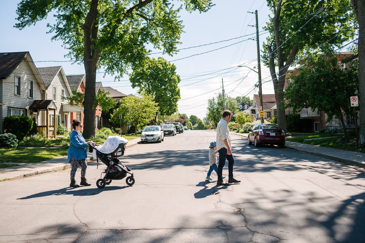 family of 4 crossing the street together during candid photo session