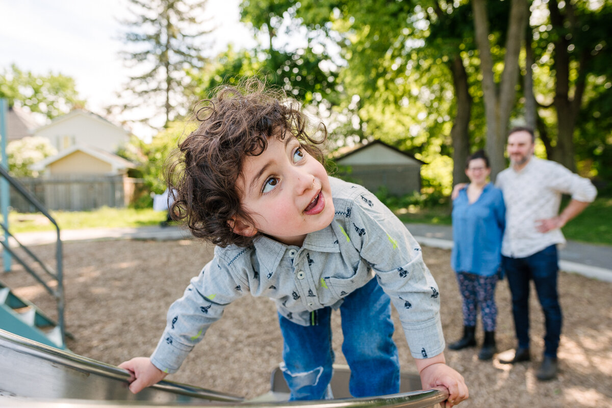 Kid climbing on the slide in the park