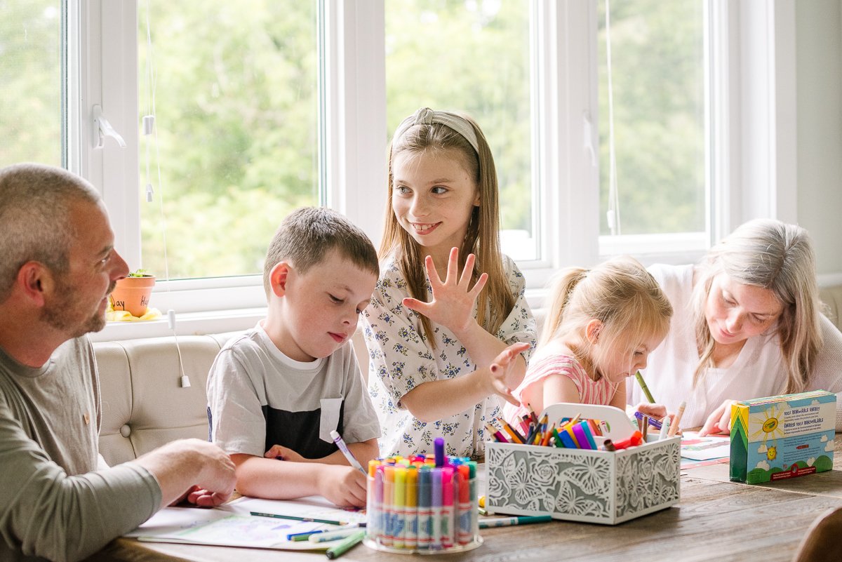 Kids coloring with their parents, a day of enjoyment together