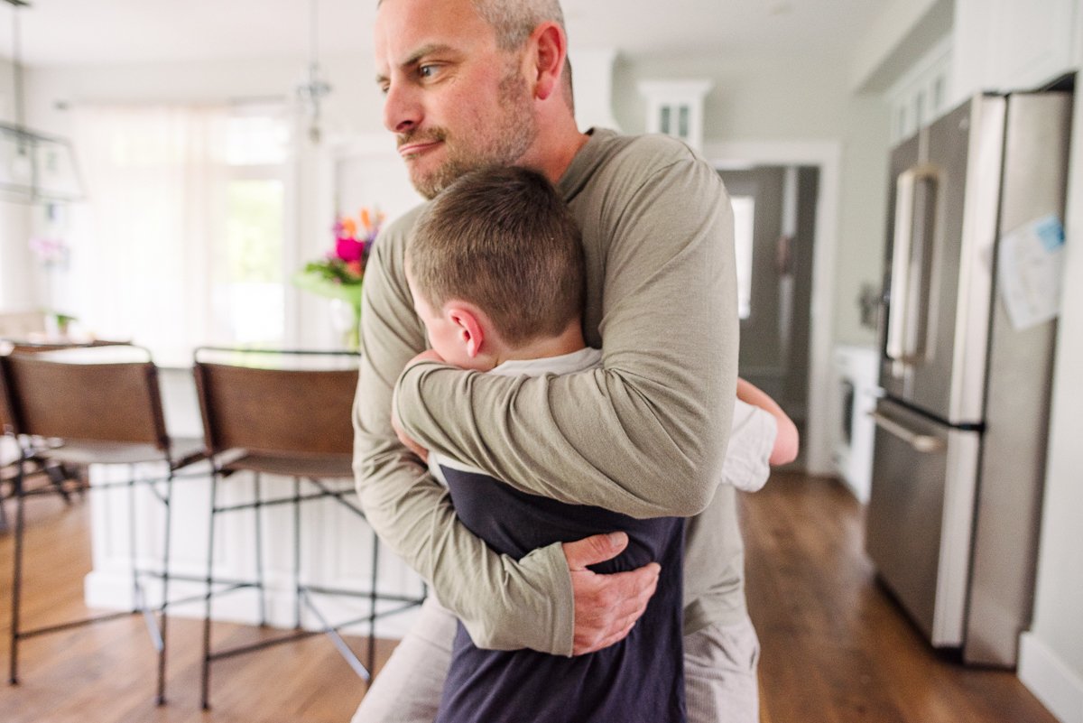 Boy hugging his dad with love