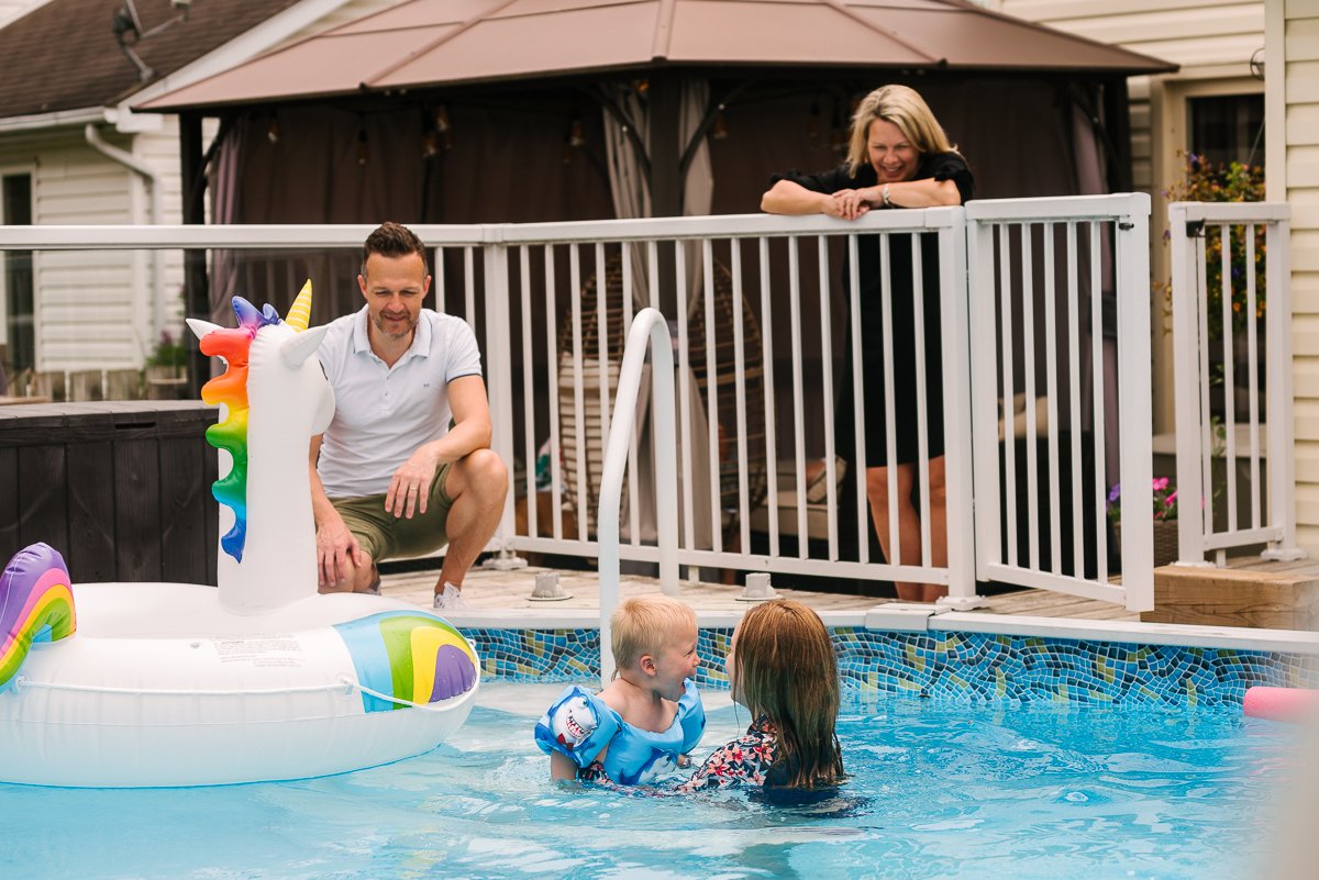 Family playing in the swimming pool