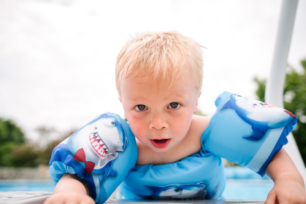 Little child playing in the swimming pool